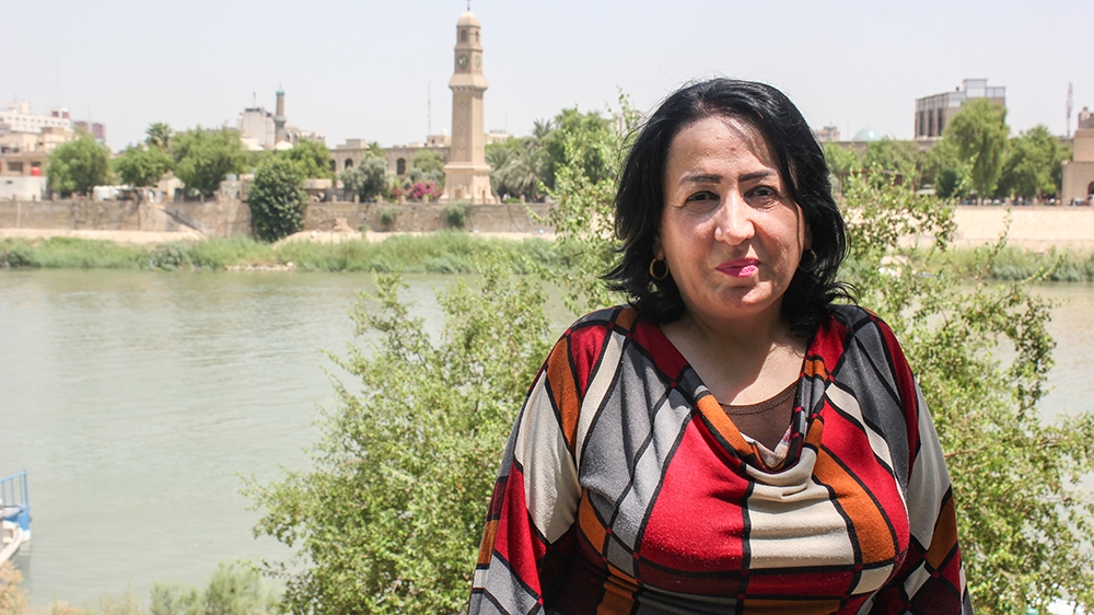 Shatha Faraj, a poet and journalist, stands in front of al-Qishla's clock tower [Arwa Ibrahim/Al Jazeera]