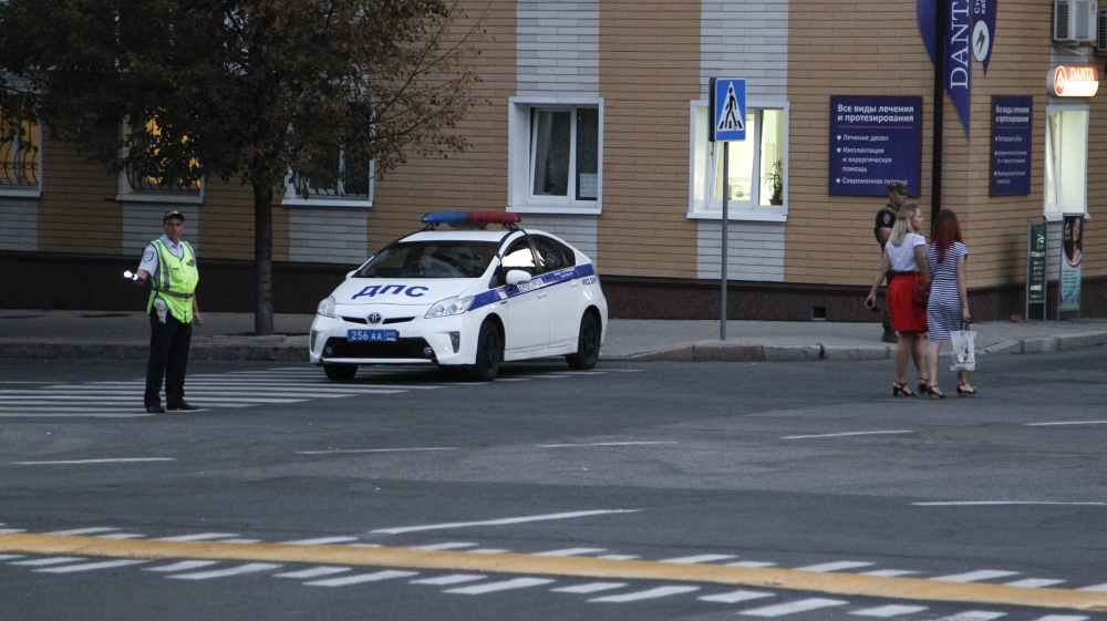 A traffic policeman blocks a road near the cafe where Zakharchenko was killed [Alexander Ermochenko/Reuters]