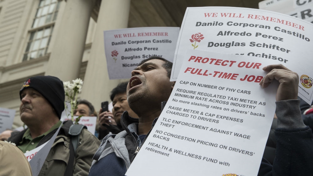 Drivers chant slogans during a rally held by the New York Taxi Workers Alliance Members in March [Mary Altaffer/AP Photo]