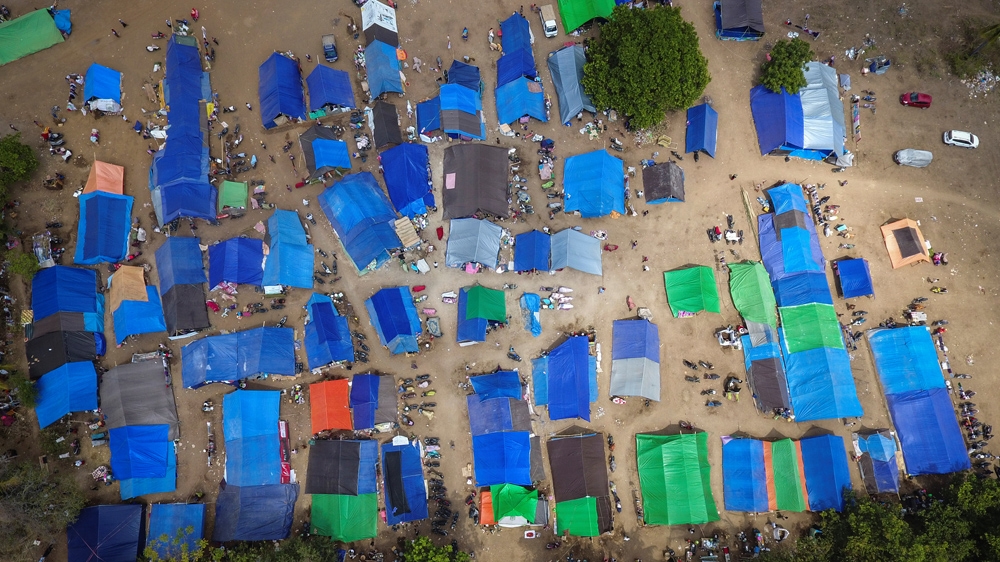 Many are sleeping in makeshift shelters after the quake flattened their homes [Antara Foto/Ahmad Subaid via Reuters]