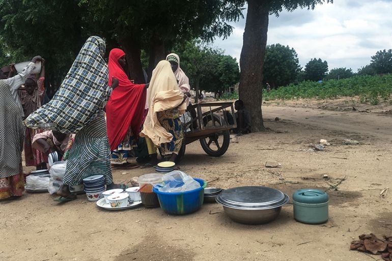 Displaced women trying to make a living off petty trading outside a camp in Zurmi, Zamfara state, Nigeria [Eromo Egbejule/Al Jazeera]