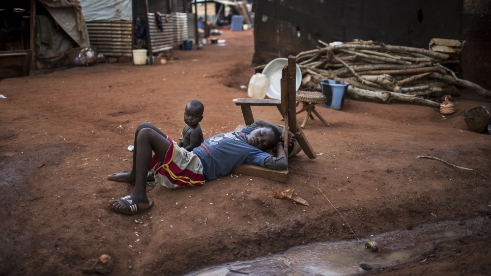 A displaced Muslim boy sleeps on the ground. For the 108 high-school-age children at the IDP site, there are no formal classes offered [Will Baxter/Al Jazeera]