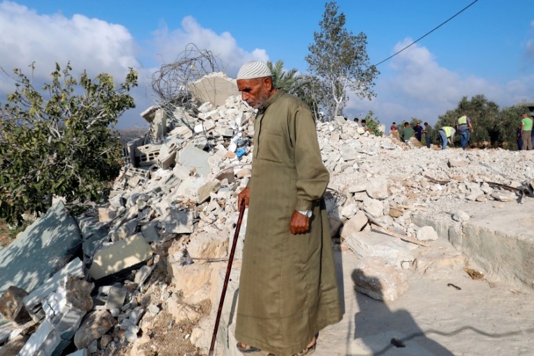 Man walks past the rubble of the family house of Palestinian assailant Mohammed Youssef after it was demolished by Israeli troops in the village of Kobar near Ramallah, in the occupied West Bank