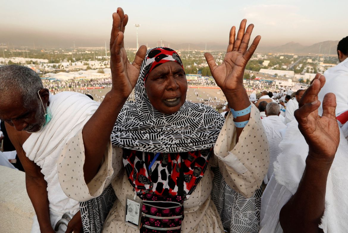 A Muslim pilgrim prays as she gathers with others on Mount Mercy on the plains of Arafat during the annual haj pilgrimage, outside the holy city of Mecca, Saudi Arabia August 20, 2018. REUTERS/Zohra B