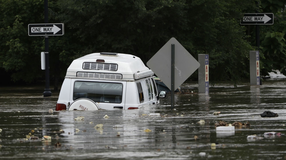 Floodwaters partly submerge a van in Darby, Pennsylvania [Matt Rourke/AP Photo]