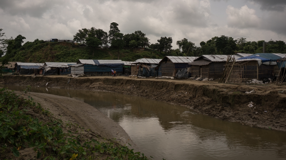 The middle of the canal marks the the physical border between Bangladesh and Myanmar [Sorin Furcoi/Al Jazeera]
