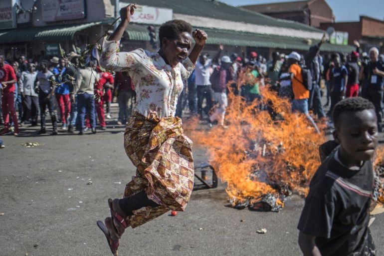 Opposition MDC party supporters protest in the streets of Harare during clashes with police Wednesday, Aug. 1, 2018. Hundreds of angry opposition supporters outside Zimbabwe''s electoral commission we