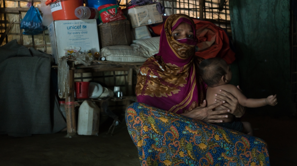 Fatima spends her days under her dim tarp-and-bamboo shelter, afraid of being judged [Sorin Furcoi/Al Jazeera]