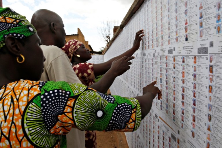 People prepare a polling station before the polls open for the presidential election in Bamako