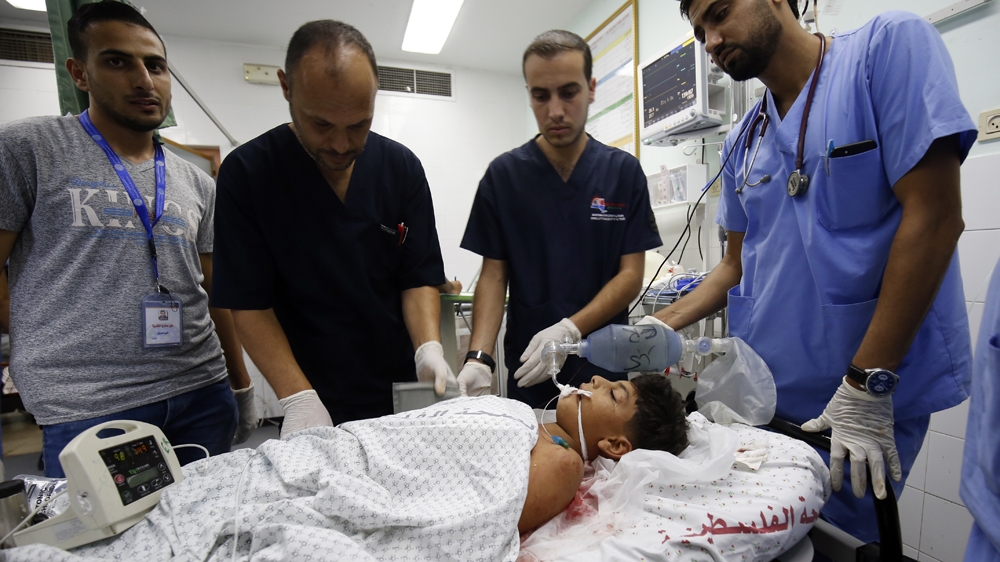 Wounded Palestinian boy Youssef Abu Zarifa receives treatment at a hospital in Khan Younis [AFP]