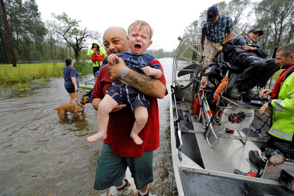 Oliver Kelly, 1 year old, cries as he is carried off the sheriff''s airboat during his rescue from rising flood waters in the aftermath of Hurricane Florence in Leland, North Carolina, U.S., September