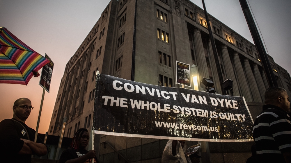 Protesters hold a banner demanding the conviction of Jason Van Dyke [Jason Patinkin/Al Jazeera]