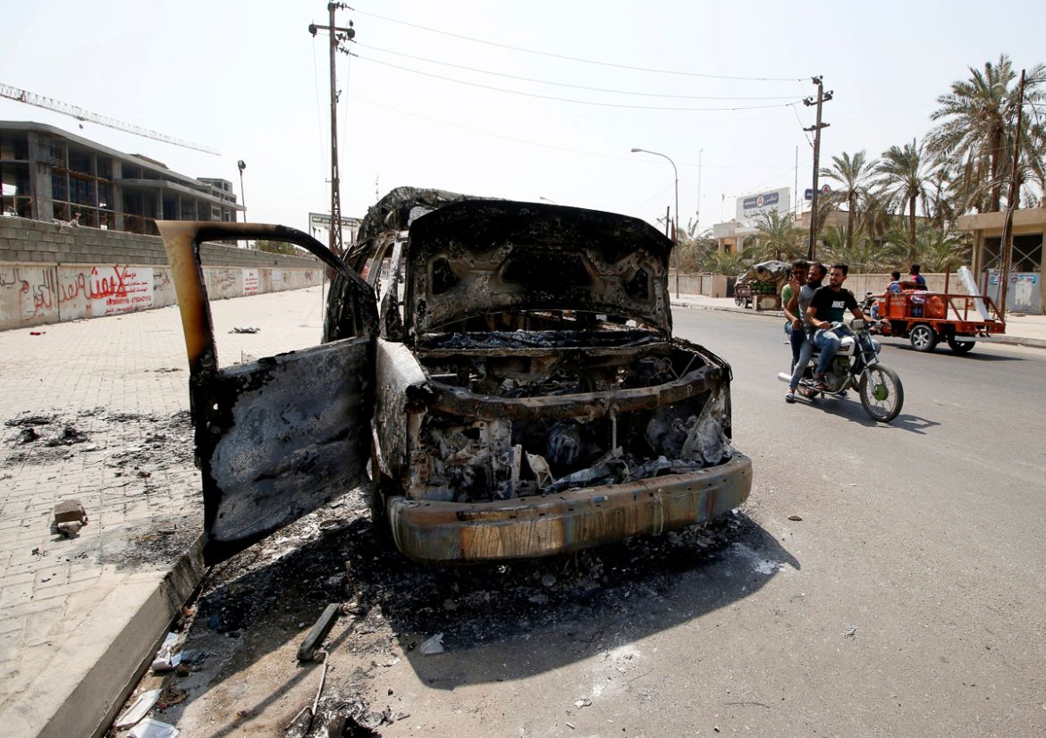 A burnt ambulance belonging to Iraq''s Popular Mobilization Forces, burned during the protests, is seen in the street in Basra, Iraq September 8, 2018. REUTERS/Essam al-Sudani