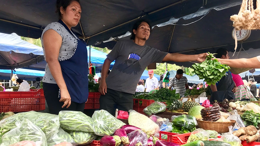 Cesar Sanchez, 26, selling at the farmers market outside the Ministry of Agriculture in Santa Tecla, just outside the capital [Heather Gies/Al Jazeera] [Daylife]