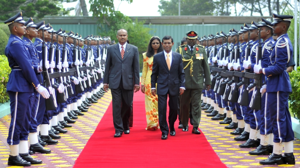 Maldives first democratically elected President Mohamed Nasheed walks through the guards of honour during his swearing in ceremony in Male on November 11, 2008 [Reuters]