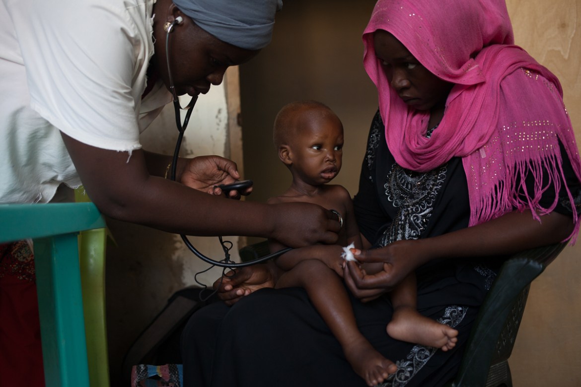 At the Betesda health center, N''Djamena, Fadne Algoni, 17, is received with her 18-month-old child Abdoulaye Ahmat, who has generalized edema and kwashiorkor. Fadne is divorced, and lives with her fat