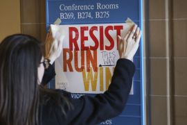 n this Saturday, Dec. 9, 2017 photo, Lianna Stroster posts a sign directing to a women''s candidate training workshop at El Centro College in Dallas.