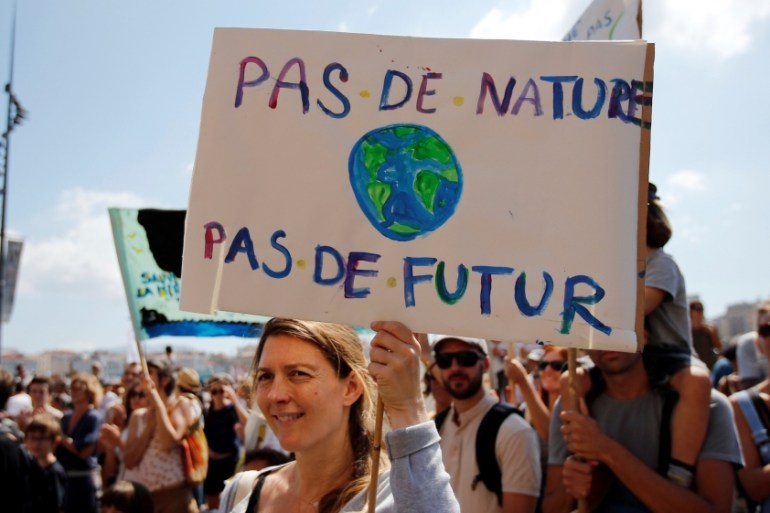 Environmental activists gather to urge world leaders to take action against climate change in Marseille