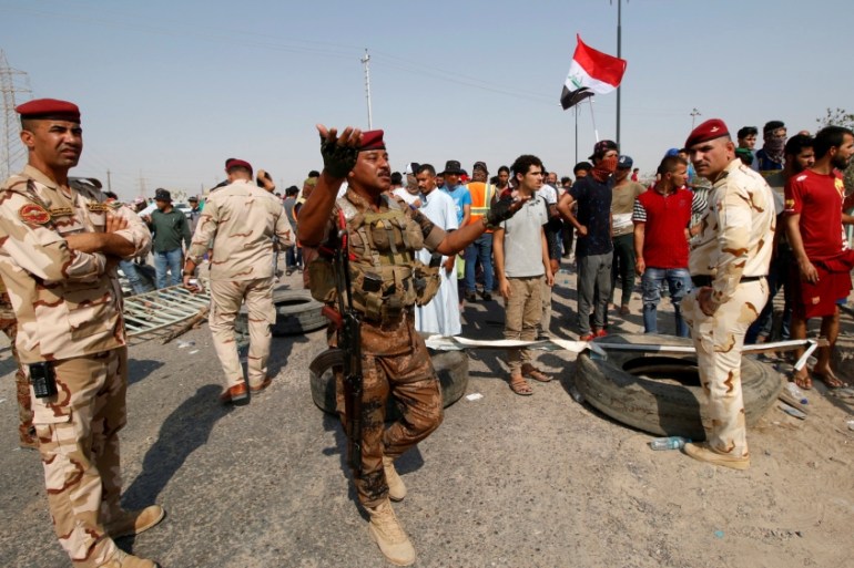 Iraqi soldiers are seen at Umm Qasr Port after it was closed by protesters in south of Basra