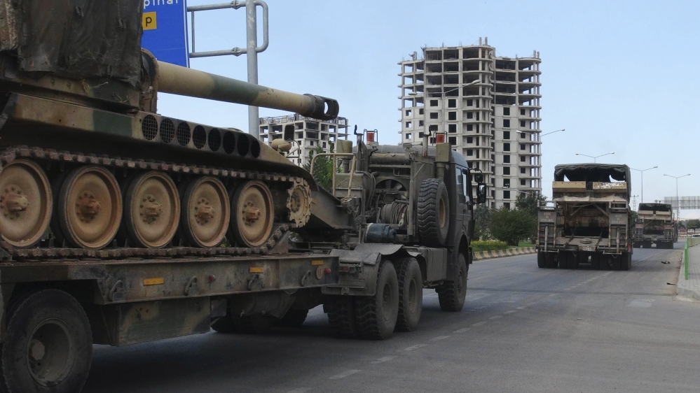 A convoy of Turkish military trucks carrying tanks destined for Syria, moves near the town of Kilis, Turkey, on September 14, 2018 [Resit Celebioglu/DHA via AP]