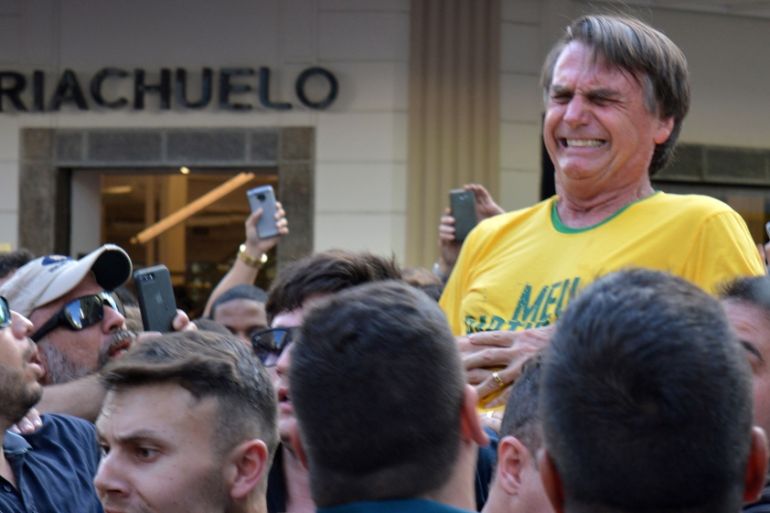 Brazilian presidential candidate Jair Bolsonaro reacts after being stabbed