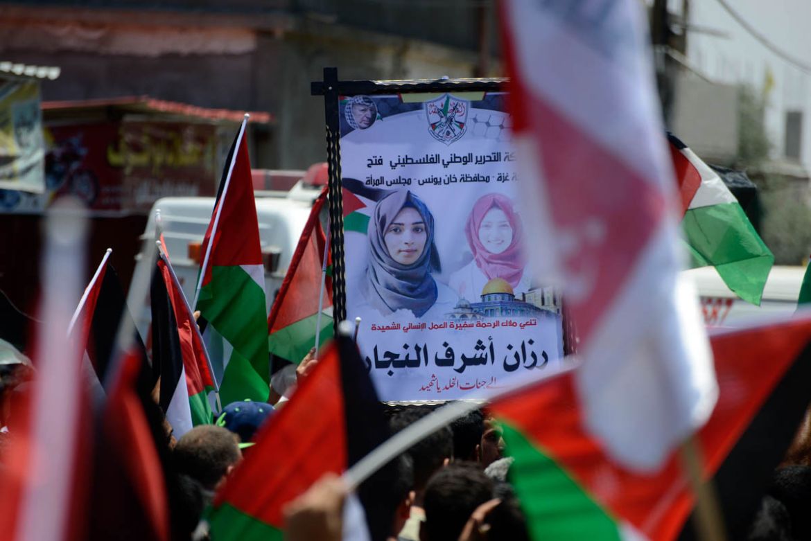 Palestinians hold a poster honouring 21-year-old Razan al-Najjar during her funeral, in the city of Khan Yunis, Gaza Strip, June 2, 2018. Razan al-Najjar, a Palestinian nurse and volunteer paramedic w