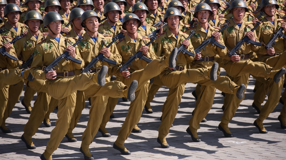 Thousands of goose-stepping soldiers paraded past a review stand where Kim Jong-un took the salute [Ed Jones/AFP]