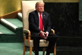 US President Donald Trump sits in the chair reserved for heads of state before delivering his address during the 73rd session of the United Nations General Assembly on September 25, 2018 [Reuters]