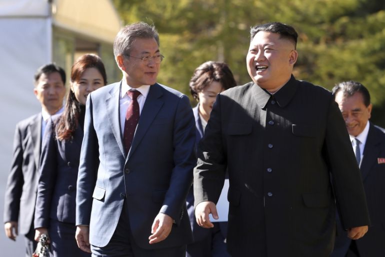 South Korean President Moon Jae-in, left, walks with North Korean leader Kim Jong Un