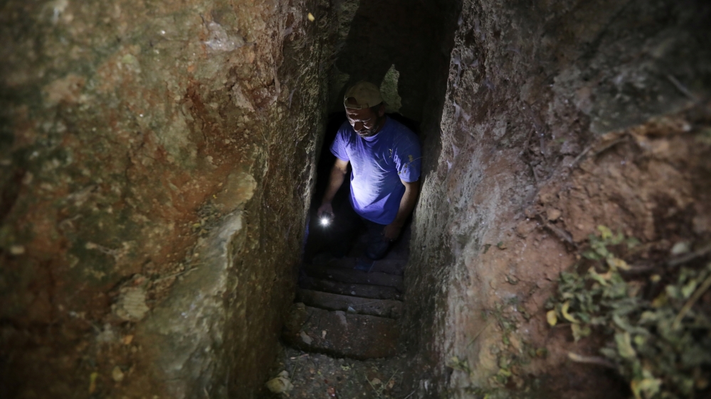 A makeshift shelter in an underground cave in Idlib [Khalil Ashawi/Reuters]