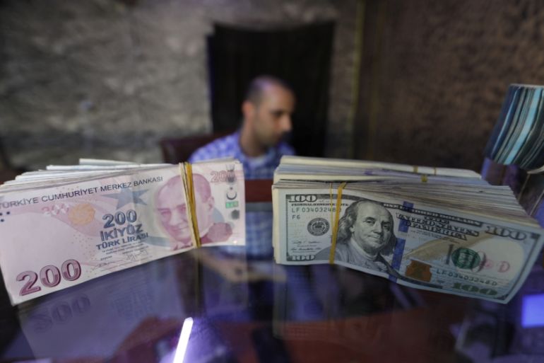 Banknotes of U.S. dollars and Turkish lira are seen in a currency exchange shop in the city of Azaz