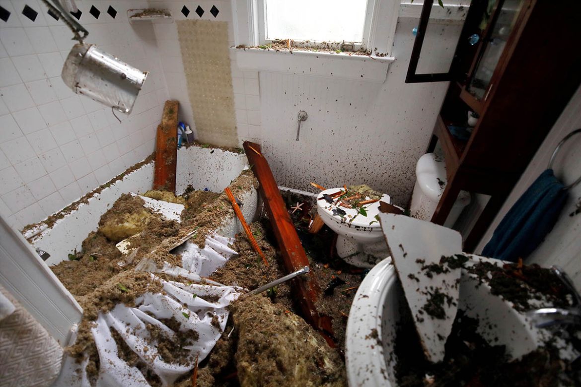 A destroyed bathroom seen in a home on which a tree landed after it was toppled by Hurricane Florence in Wilmington, North Carolina, U.S., September 14, 2018. REUTERS/Jonathan Drake