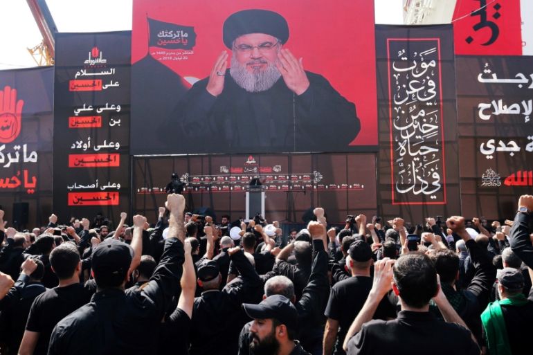 Lebanon''s Hezbollah leader Sayyed Hassan Nasrallah gestures as he addresses his supporters via a screen