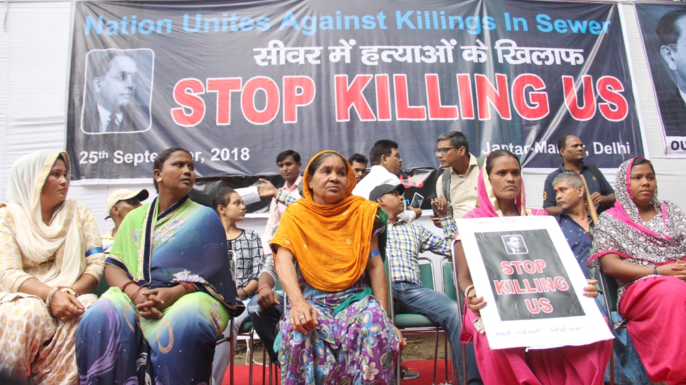 Families of people who died in sewer tanks participate in a protest organised by Safai Karamchari Andolan in New Delhi on September 25 [Nasir Kachroo/Al Jazeera]