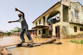 A man makes his way through flood waters in Kogi State, Nigeria September 17, 2018. REUTERS/Afolabi Sotunde