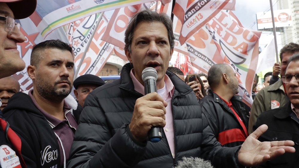 Haddad (centre) served as mayor of Sao Paulo for one term, from 2013 to 2017 [File: Andre Penner/AP]