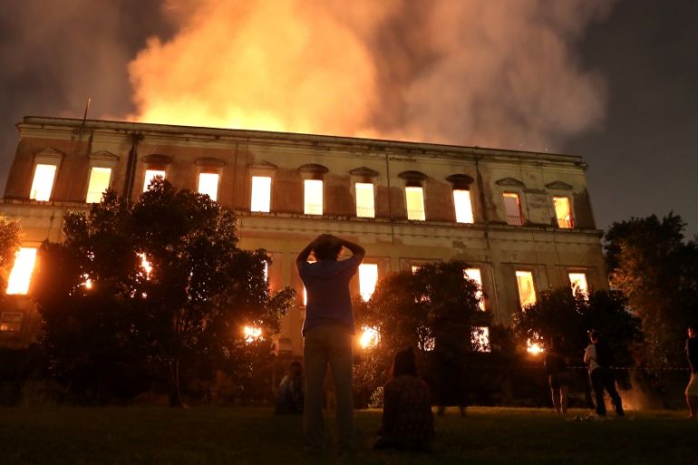 People watch as a fire burns at the National Museum of Brazil in Rio de Janeiro