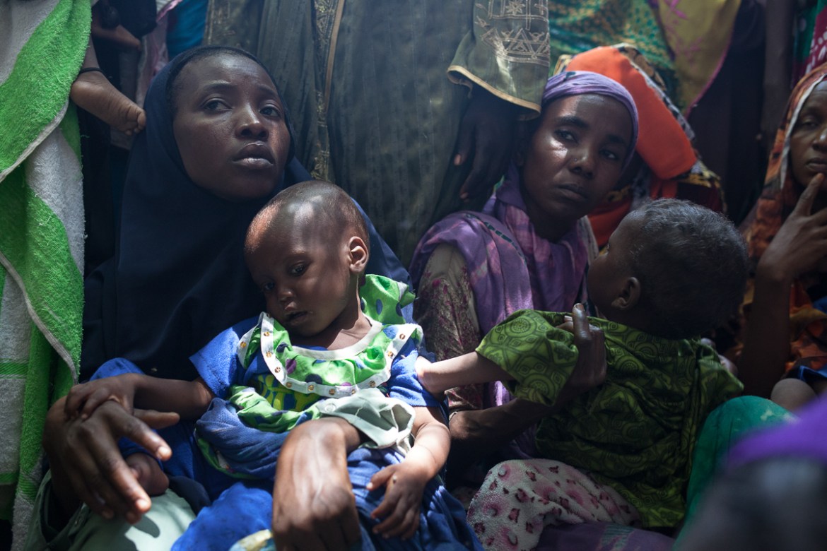 At the Ndjari neighbourhood health centre, Daouda Hawa (right), 22 years old, and her child Fatime Mohamat, 2 year old, await examination by health workers. Fatime has been sick for three months, her