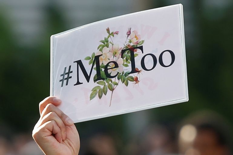A protester raises a placard reading "#MeToo" during a rally against harassment at Shinjuku shopping and amusement district in Tokyo, Japan, April 28, 2018. Picture taken April 28, 2018. REUTERS/Issei