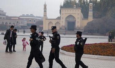 Uighur security personnel patrol near the Id Kah Mosque in Kashgar in western China''s Xinjiang region.