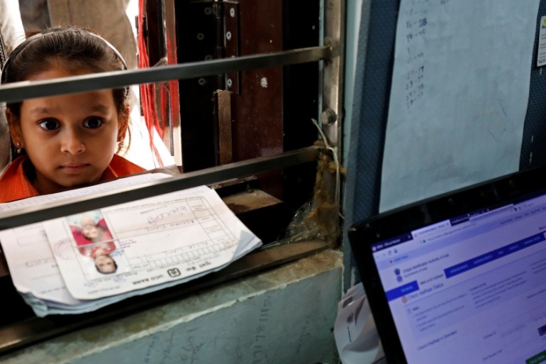 A girl waits for her turn to enrol for the Unique Identification database system, also known as Aadhaar, at a registration centre in New Delhi