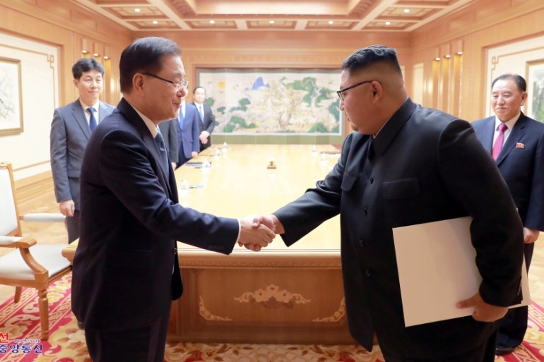 A South Korean envoy shakes hands with North Korean leader Kim Jong Un during their meeting in Pyongyang
