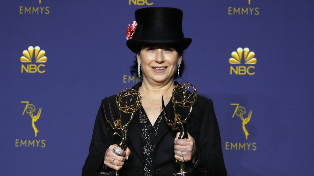 Amy Sherman-Palladino poses backstage with her Outstanding Writing for a Comedy Series and Outstanding Directing for a Comedy Series awards for The Marvelous Mrs Maisel [Mike Blake/Reuters]