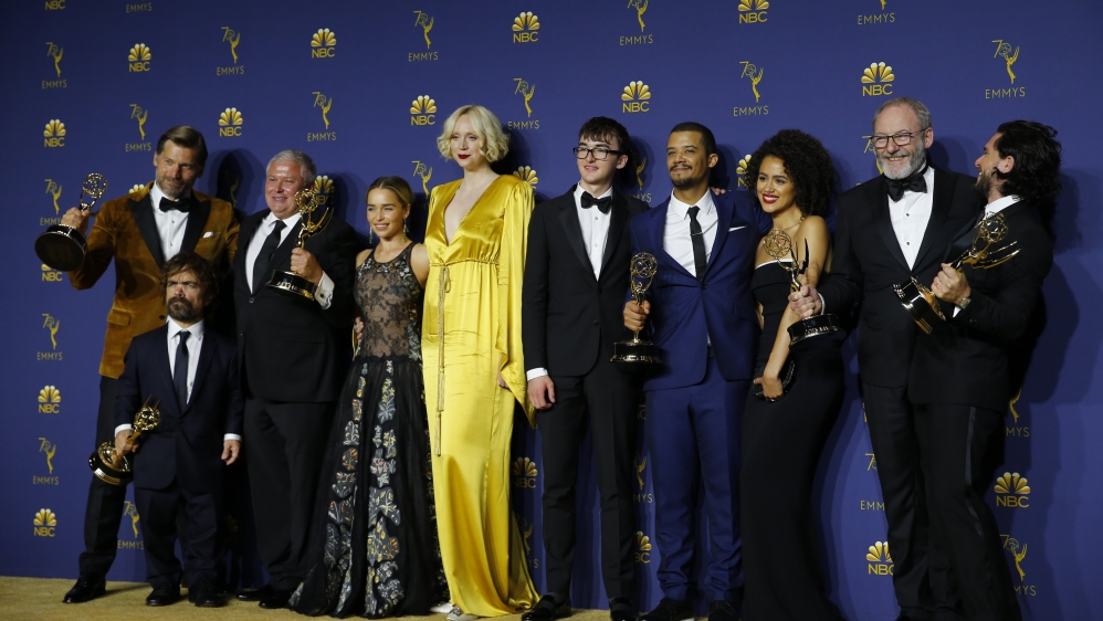 The cast poses backstage with the Outstanding Drama Series award for Game of Thrones [Mike Blake/Reuters]