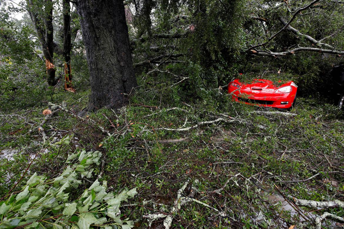 Leaves, branches and other debris surround and cover a sports car after Hurricane Florence hit Wilmington, North Carolina, U.S., September 14, 2018. REUTERS/Jonathan Drake TPX IMAGES OF THE DAY