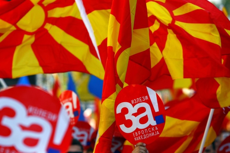 People hold placards reading ÔYes for European MacedoniaÕ during a march in support of a referendum in Skpoje