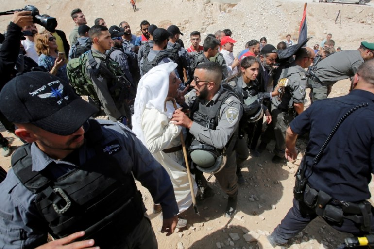 Palestinian man scuffles with Israeli troops as they protest against Israel''s plan to demolish the Palestinian Bedouin village of Khan al-Ahmar, in the occupied West Bank