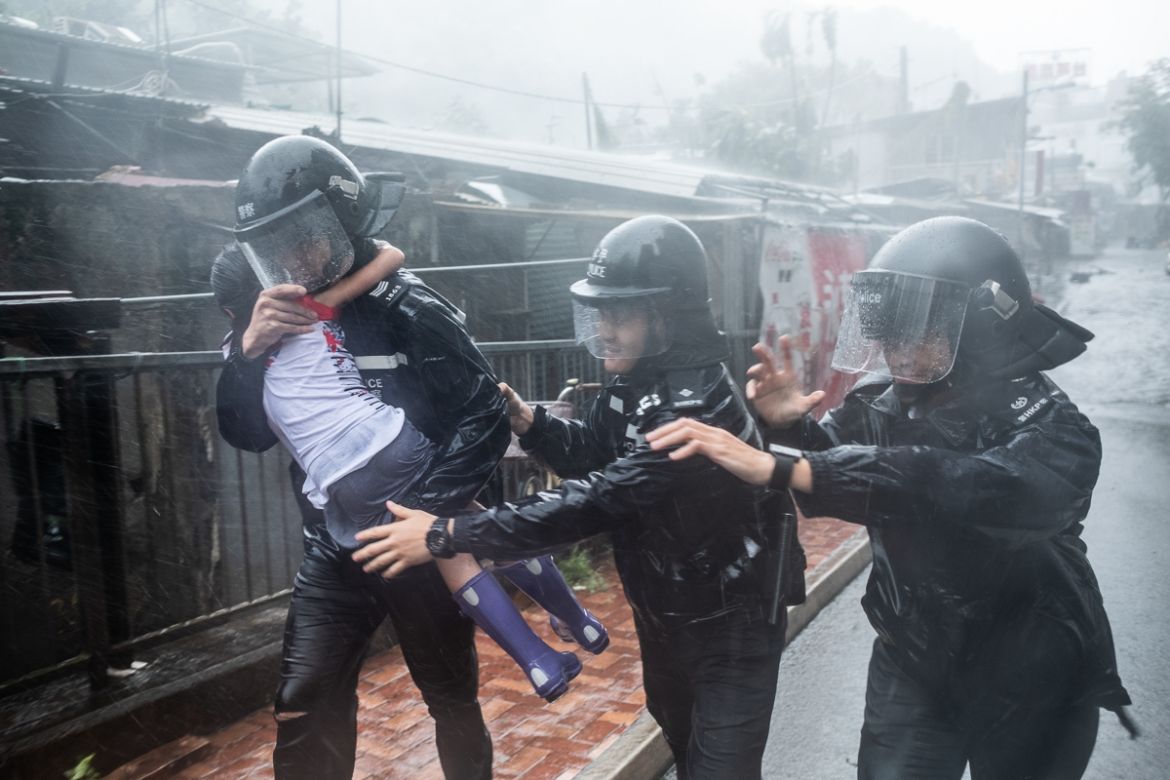 HONG KONG, HONG KONG - SEPTEMBER 16: Police officers carry a girl out of a collapsed school on September 16, 2018 in Hong Kong, Hong Kong. City officials raised the storm alert to T10, it''s highest le