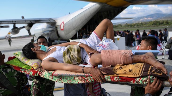 An injured man is evacuated on a military aircraft following an earthquake and tsunami at Mutiara Sis Al Jufri Airport in Palu, Central Sulawesi, Indonesia September 30, 2018 in this photo taken by A