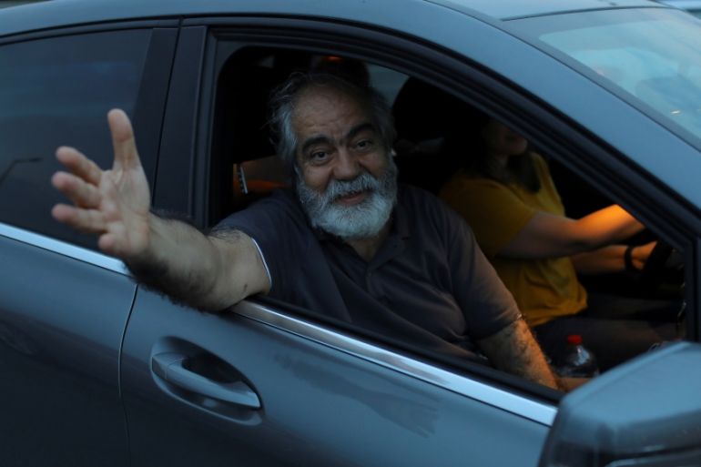 Journalist Mehmet Altan waves to media after being released from the prison in Silivri, near Istanbul